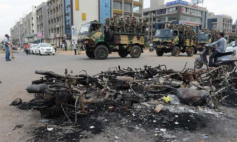 Troops patrol an Indian city after communal riots