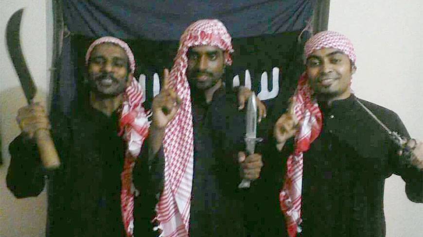 Tamim Chaudhury inspired these militants to kill people with machetes which they proudly hold for this shot . 
