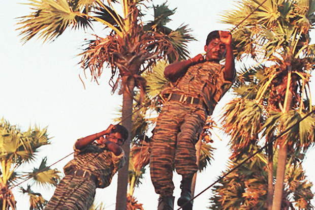 Liberation Tigers of Tamil Eelam (LTTE) in Sri Lanka's northern peninsula of Jaffna training in September 1994, just over a year before they were driven out the area. The Sri Lankan government 26 January outlawed the guerrilla group after accusing them of bombing the country's holiest Buddhist shrine.  PHOTO/Sena VIDANAGAMA/AFP 
