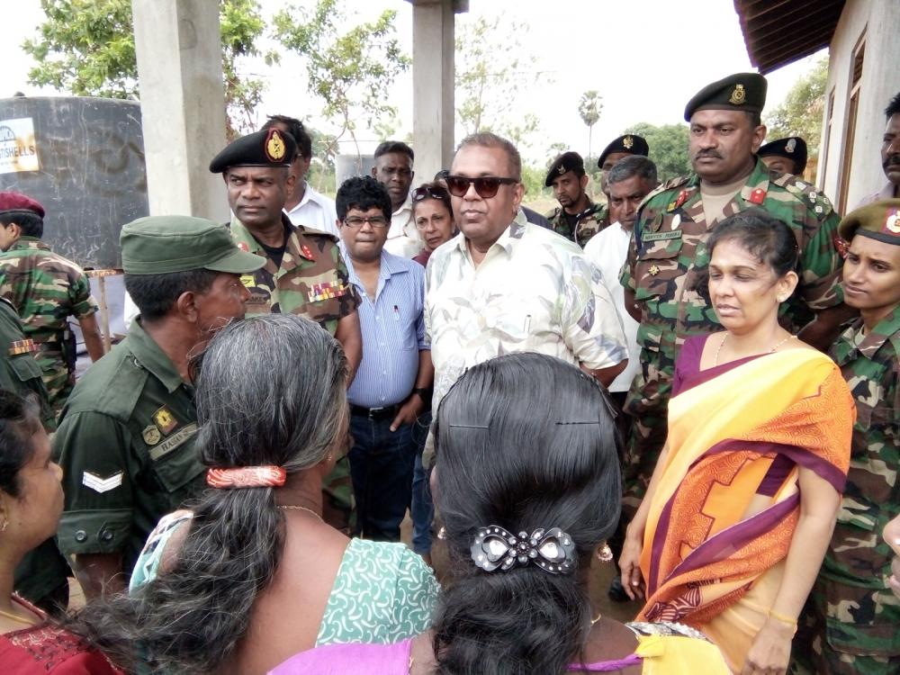 Sri Lankan Foreign Minister Mangala Samaraweera with army personnel and Tamil civilians at Keerimalai in Jaffna where the army had handed over to civilians lands seized during the war.