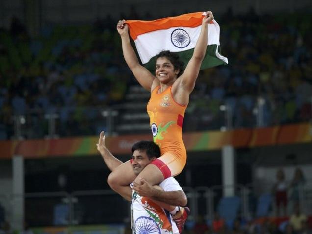 Sakshi Malki on her victory lap after winning a winning a bronze in the 58 kg category 