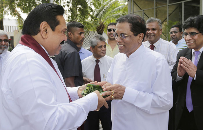 Sirisena offering Rajapaksa betel leaves as a sign of friendship just before he defected from the SLFP to fight for the Sri Lanka Presidency as the Joint Opposition candidate against Rajapaksa 