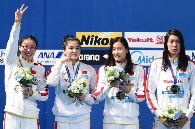 Team China celebrates its gold medal during the podium ceremony for the women's 4x100m medley relay swimming event at the 2015 FINA World Championships in Kazan on August 9, 2015. Shi Jinglin, Lu Ying, Fu YuanHui and Shen Duo competed in the event. AFP PHOTO / FRANCOIS XAVIER MARIT        (Photo credit should read FRANCOIS XAVIER MARIT/AFP/Getty Images)
