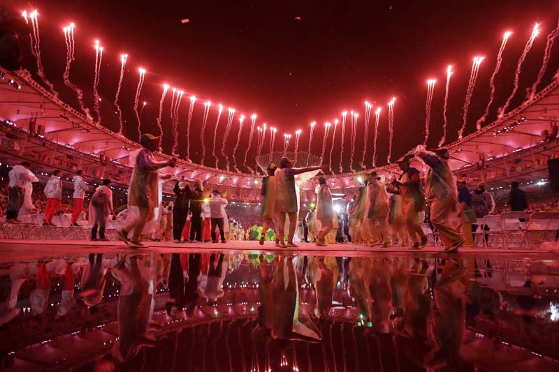 Dancers and fireworks are reflected in a puddle during the closing ceremony in the Maracana stadium at the Rio Olympics in Rio de Janeiro, Brazil, on Sunday, August 21, 2016. Photo: AP