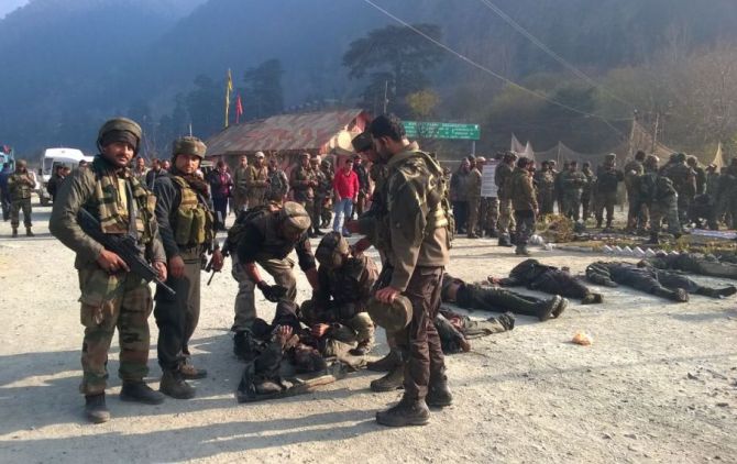 Indian soldiers examine bodies of slain Pakistan-based terrorists in the Uri army camp. 