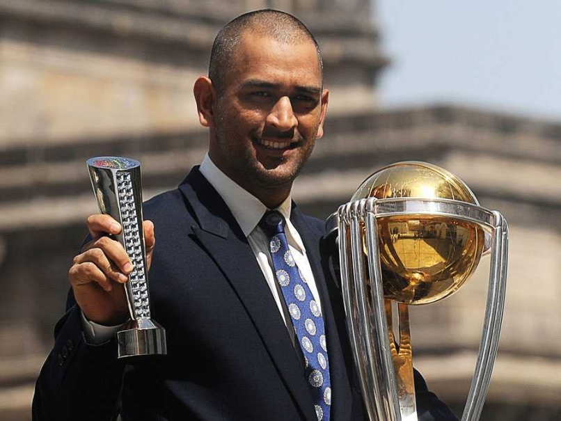 Mahendra Singh Dhoni holding the World Cup