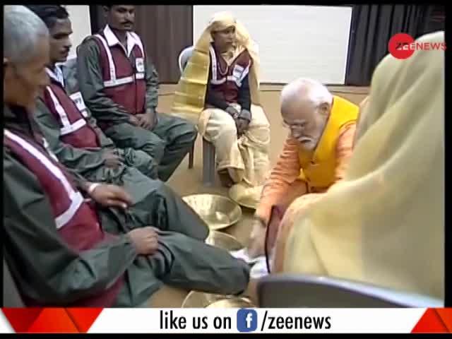 Modi washes the feet of sanitary workers at the Kumbh mela