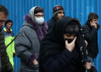 An Iranian woman wears protective mask to prevent contracting a coronavirus, as she walks at Grand Bazaar in Tehran, Iran February 20, 2020. WANA (West Asia News Agency)/Nazanin Tabatabaee via REUTERS