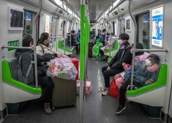 People wearing protective face masks ride in a subway in Wuhan on March 29, 2020.PHOTO: EPA-EFE