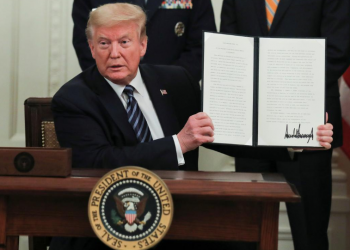 U.S. President Donald Trump holds up a presidential proclamation declaring a "Older Americans Month 2020" during an event about senior citizens and the coronavirus disease (COVID-19) pandemic in the East Room at the White House in Washington, U.S., April 30, 2020. REUTERS/Carlos Barria