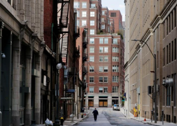 FILE PHOTO: A pedestrian walks on an empty street amid the coronavirus disease (COVID-19) outbreak, in Boston, Massachusetts, U.S., May 12, 2020. REUTERS/Brian Snyder/File Photo