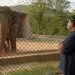 Pakistani prime minister advisor to climate change Malik Amin Aslam stands as Elephant Kaavan is seen behind a fence at the Marghazar Zoo in Islamabad on July 18, 2020. - A Pakistani court approved the relocation of a lonely and mistreated elephant to Cambodia on July 18 after the pachyderm became the subject of a high-profile rights campaign backed by music star Cher. (Photo by Farooq NAEEM / AFP) (Photo by FAROOQ NAEEM/AFP via Getty Images)