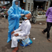 A healthcare worker wearing personal protective equipment (PPE) takes a swab from a man to test him for the coronavirus disease (COVID-19) in a street in Ahmedabad, India, July 7, 2020. REUTERS/Amit Dave
