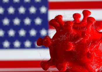 FILE PHOTO: A 3D-printed coronavirus model is seen in front of a U.S. flag on display in this illustration taken March 25, 2020. REUTERS/Dado Ruvic/Illustration/File Photo