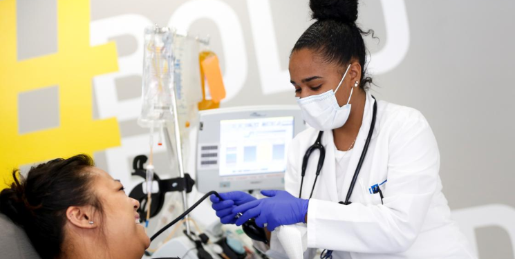 FILE PHOTO: Phlebotomist Jenee Wilson talks with Melissa Cruz, an ER technician for Valley Medical Center who has recovered from the coronavirus disease (COVID-19) she contracted from a patient, as she finishes donating convalescent plasma at the Central Seattle Donor Center of Bloodworks Northwest during the outbreak in Seattle, Washington, U.S. April 17, 2020. The plasma from recovered patients will be used in an experimental treatment study for current coronavirus patients. REUTERS/Lindsey Wasson