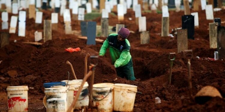 A worker prepares new graves for Covid-19 victims at the Pondok Ranggon cemetery in Jakarta.PHOTO: REUTERS