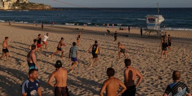 People play rugby at Bondi Beach in Sydney, Australia. [Loren Elliott/ Reuters]