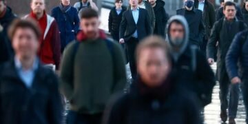 People walk across London Bridge. REUTERS/Hannah McKay/File Photo