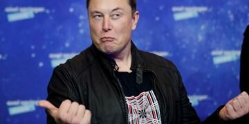 FILE PHOTO: SpaceX owner and Tesla CEO Elon Musk grimaces after arriving on the red carpet for the Axel Springer award, in Berlin, Germany, December 1, 2020. REUTERS/Hannibal Hanschke/Pool