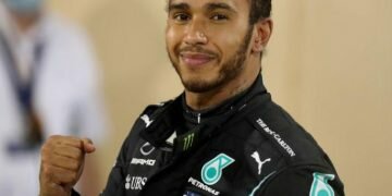 FILE PHOTO: Formula One F1 - Bahrain Grand Prix - Bahrain International Circuit, Sakhir, Bahrain - November 29, 2020 Mercedes' Lewis Hamilton celebrates after winning the race Pool via REUTERS/Tolga Bozoglu