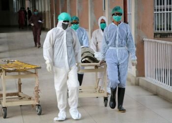 Health officials shift a coffin containing body of a victim who reportedly died from Covid-19, at a hospital in Abbottabad, Pakistan, 04 May 2020 [Sultan Dogar/EPA]