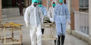 Health officials shift a coffin containing body of a victim who reportedly died from Covid-19, at a hospital in Abbottabad, Pakistan, 04 May 2020 [Sultan Dogar/EPA]