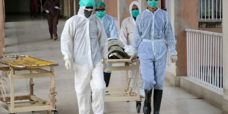 Health officials shift a coffin containing body of a victim who reportedly died from Covid-19, at a hospital in Abbottabad, Pakistan, 04 May 2020 [Sultan Dogar/EPA]