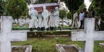 A veteran who died of COVID-19 is buried in a North Sumatra cemetery. People over 60 years of age represent only 10 percent of Indonesia’s population, but account for 39 percent of coronavirus deaths [Dedi Sinuhaji/EPA]