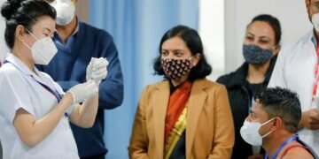 Sanitation worker Manish Kumar, who according to the officials is the first person in the country vaccinated against the COVID-19, prepares to receive a dose of Bharat Biotech's COVAXIN during the coronavirus disease (COVID-19) vaccination campaign at All India Institute of Medical Sciences (AIIMS) hospital in New Delhi, India, January 16, 2021. REUTERS/Adnan Abidi