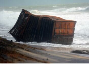 Sri Lankan security personnel remove debris washed ashore from container ship X-Press Pearl