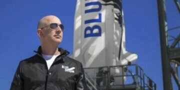 Jeff Bezos at the Blue Origin launch pad with a New Shepard rocket in the background. (Image credit: Blue Origin)