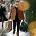 A woman wearing a face mask to guard against Covid-19 carries bags of shopping along Oxford Street in London. (Photo: AP)