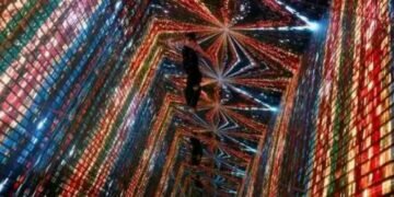 A visitor is pictured in front of an immersive art installation titled ‘Machine Hallucinations — Space: Metaverse’ by media artist Refik Anadol, which will be converted into NFT and auctioned online at Sotheby's, at the Digital Art Fair, in Hong Kong, China.