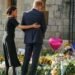 Prince Harry and Meghan, Duchess of Sussex, look at the floral tributes for the late Queen Elizabeth II outside Windsor Castle, in Windsor, England, Sept. 10, 2022. (AP Photo/Martin Meissner) (AP)