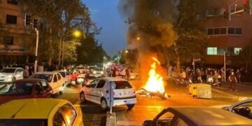 A police motorcycle burns during a protest over the death of Mahsa Amini. (Image: Reuters)