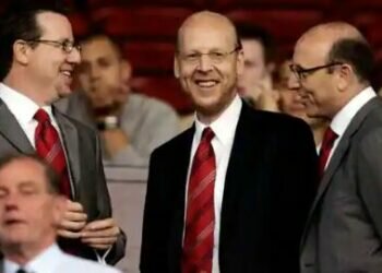 Manchester United board members Bryan Glazer, left, Avi Glazer, center, and Joel Glazer take their seats in the stands