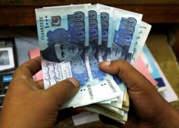 A trader counts Pakistani rupee notes at a currency exchange booth in Peshawar, Pakistan December 3, 2018